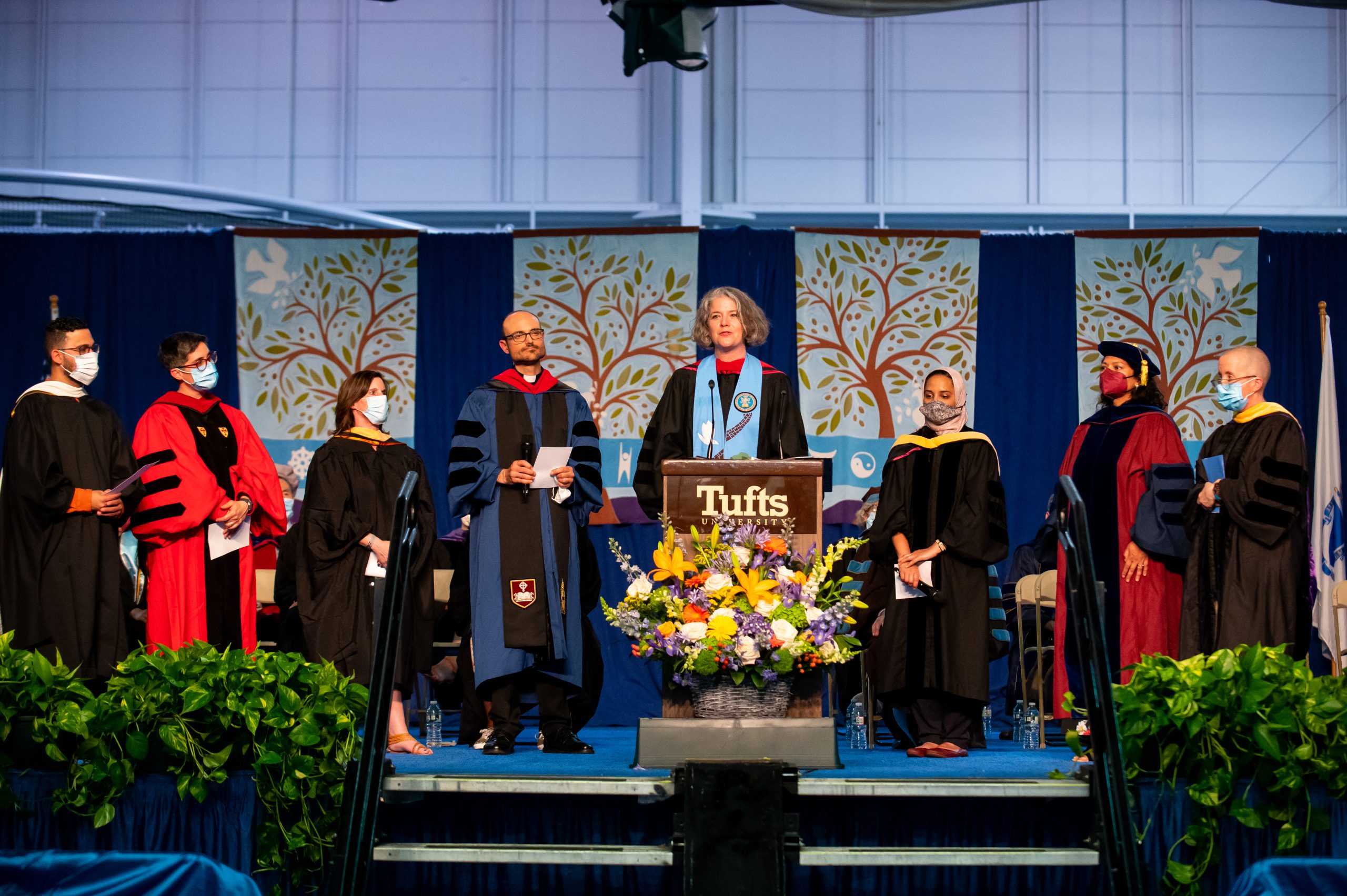 People on a stage in academic regalia