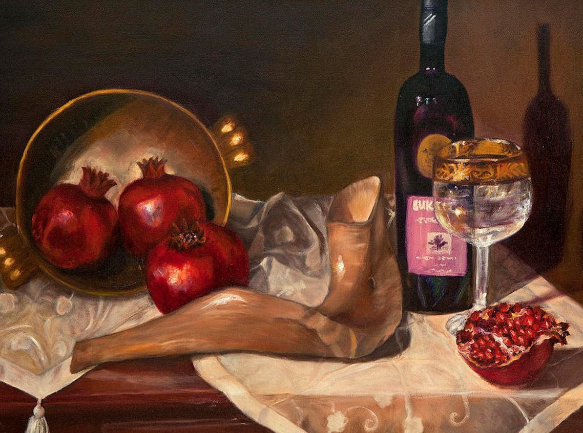 Pomegrantes, and horn and wine on a table